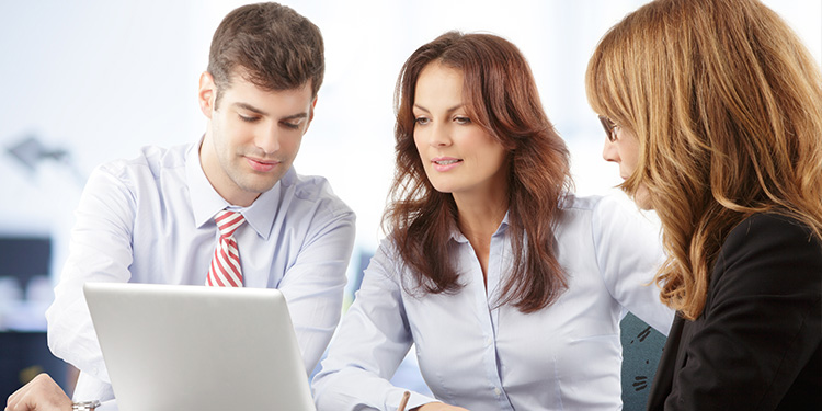 Agents looking at laptop